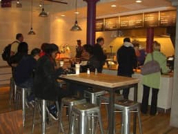 Customers ordering at a fast-casual counter