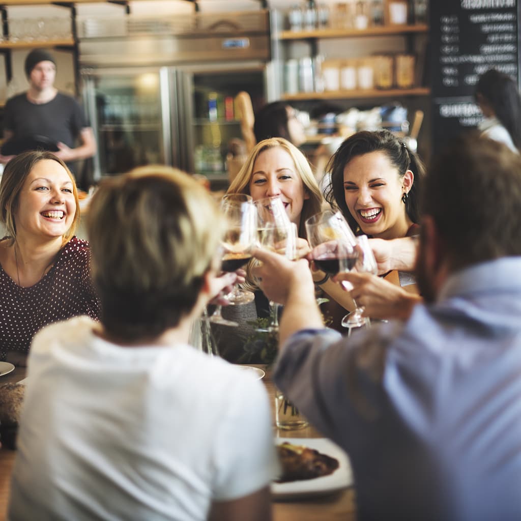 Guests raising glasses together at a restaurant table